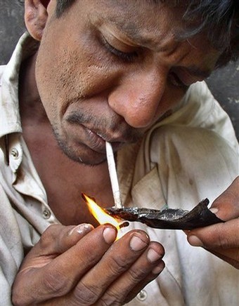 A Man Smoking Heroin Off of Foil